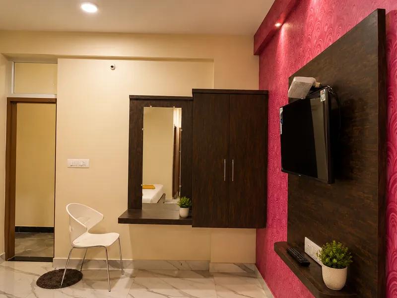 Wardrobe, dressing mirror and television in a guest room